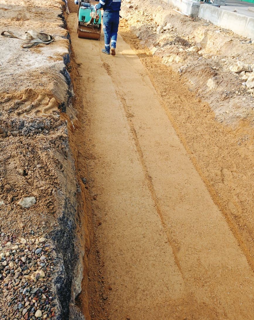 Trench preparation with worker and equipment